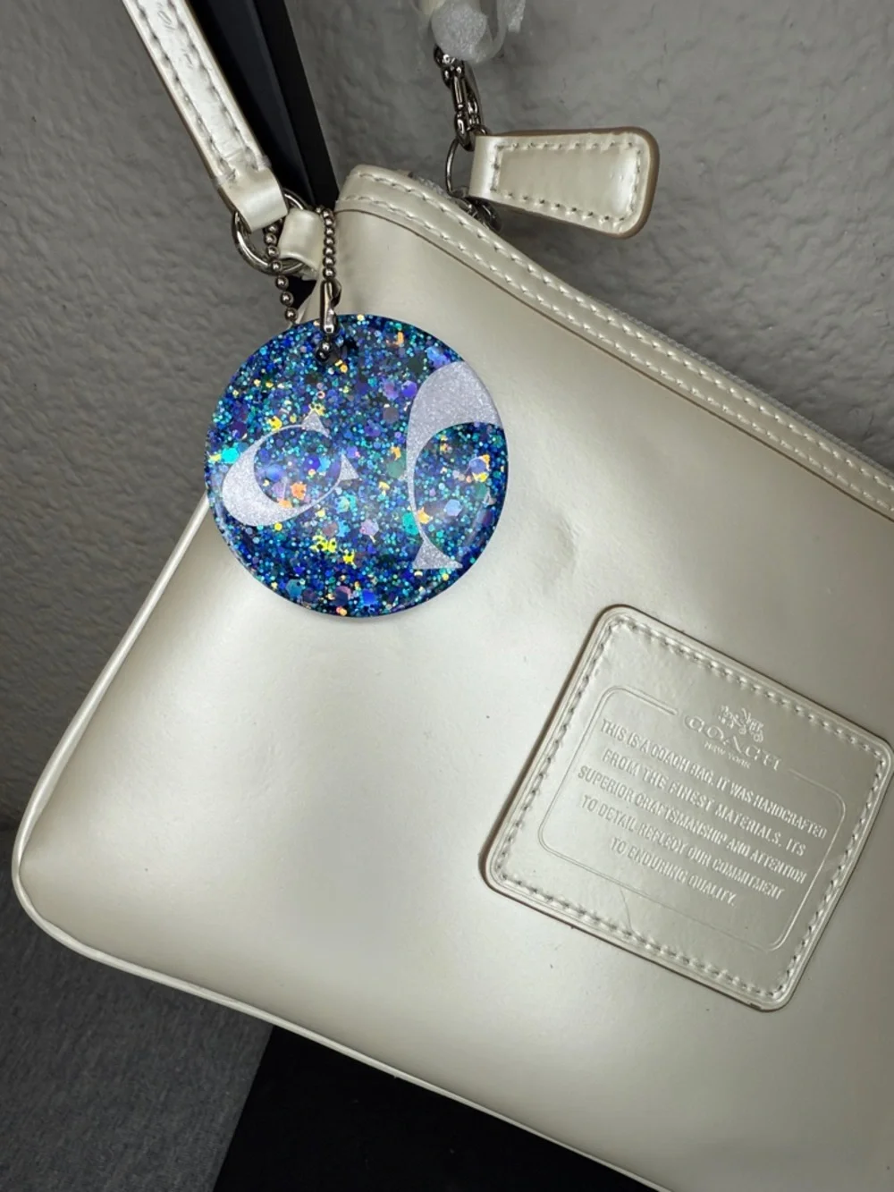 Coach Shimmering Ivory Leather Large Wristlet Clutch with Blue Glitter Charm